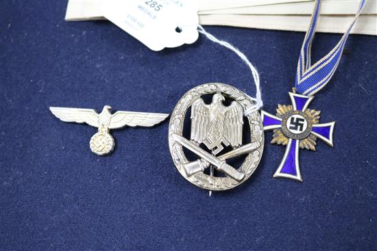 A German Red Cross armband and paperwork, a mothers cross, a general assault badge